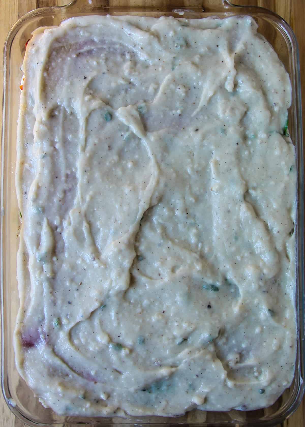 Another layer of béchamel sauce spread over the contents in the lasagna pan. 